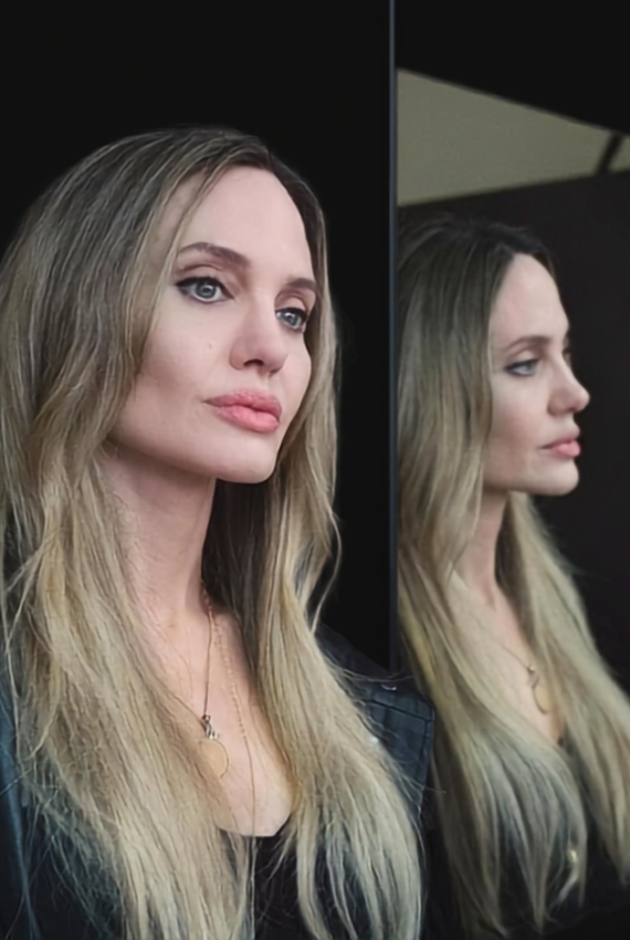 Angelina Jolie in primo piano con la sua immagine riflessa